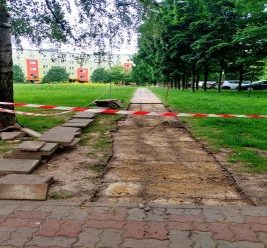 Trwają prace przy przełożeniu kostki wzdłuż łąki kwietnej